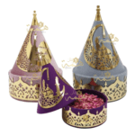 Coffrets cadeaux Aïd Moubarak en velours rose, gris et violet avec finitions dorées et pétales de fleurs.